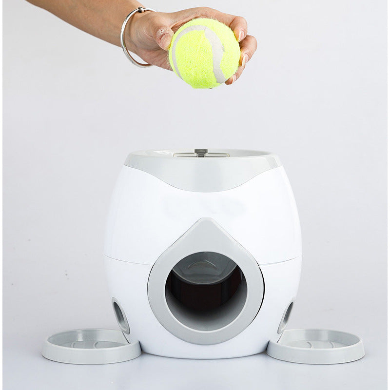 An image of a person dropping a tennis ball into the Double-Hole Dog Tennis Food Reward Machine sold by Saint N Mike.
