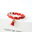  Red collar with a red tassel charm. 