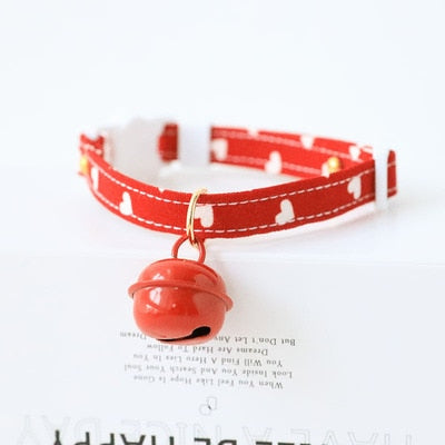Red collar with a red bell charm. 